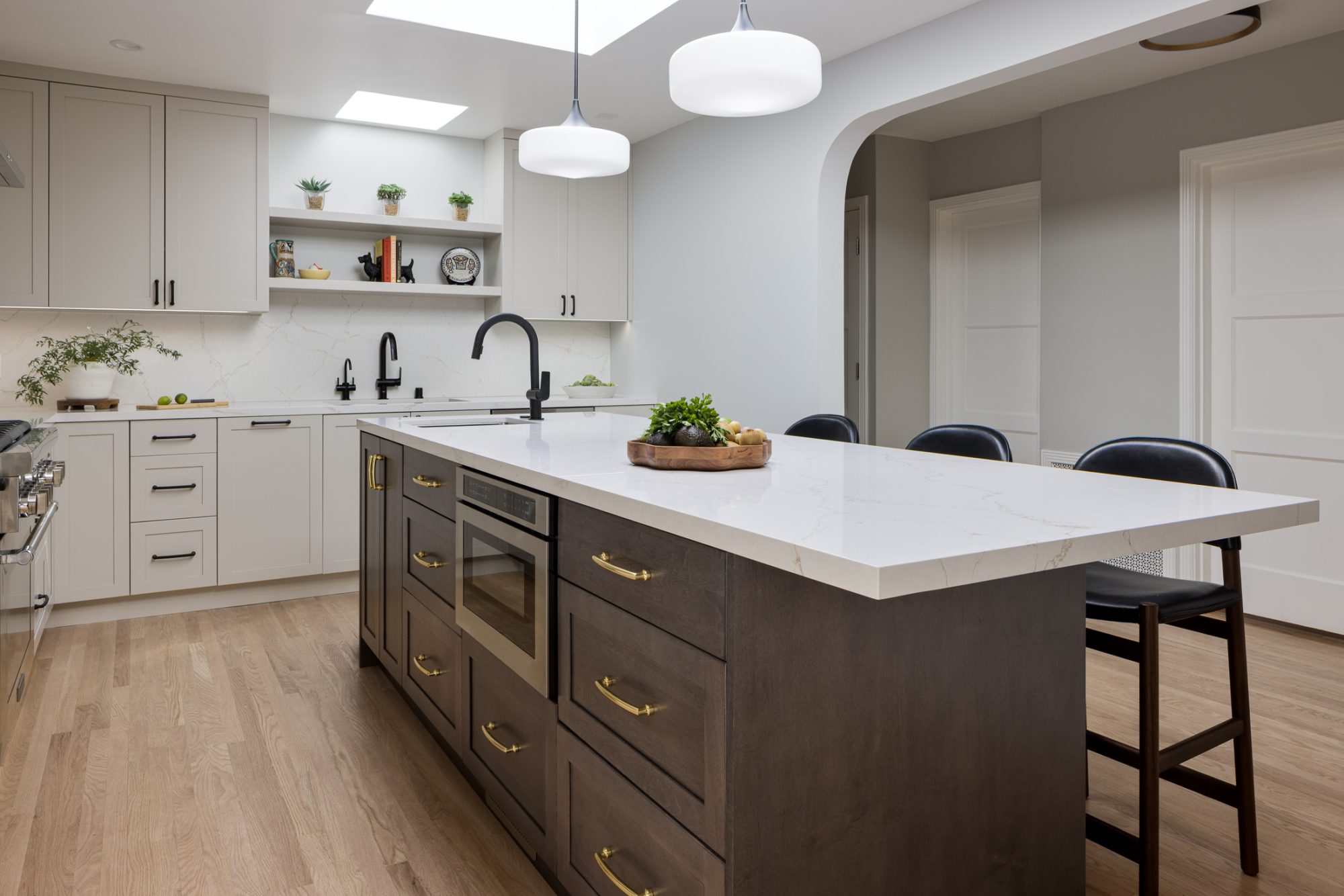 Arcadia kitchen with cream cabinetry and brass hardware island