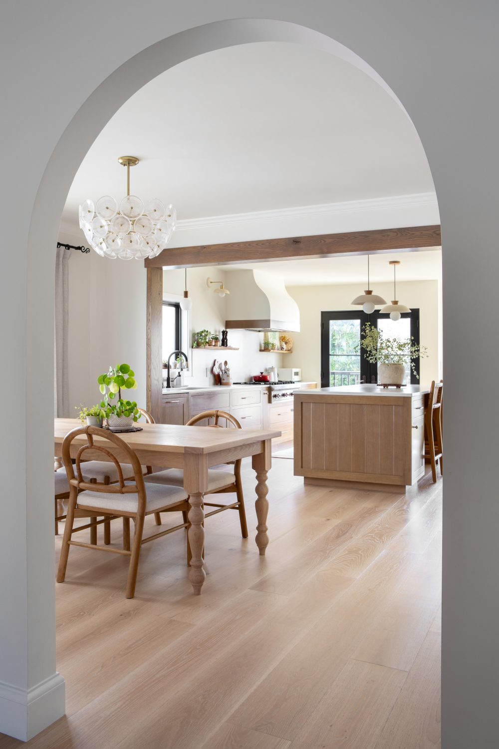 Tempe modern kitchen and dining viewed through a plaster archway