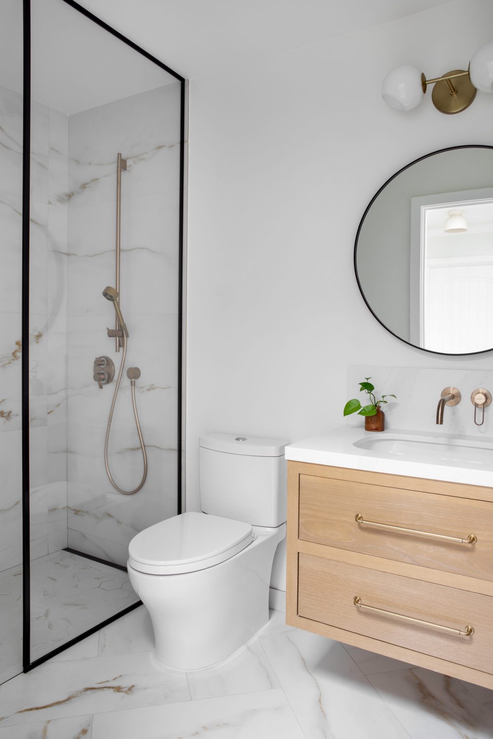Tempe modern powder bath with floating oak vanity and round mirror
